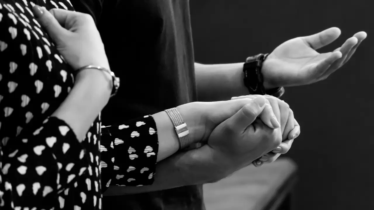 A oração no casamento representada por duas mãos dadas em posição de oração