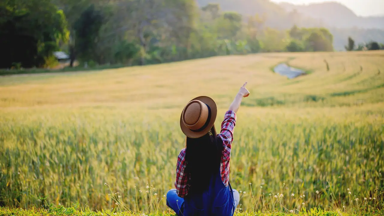 Quando Deus nos convida a parar para avaliaar e seguir adiante ilustrado por uma mulher sentada ao ar livre.